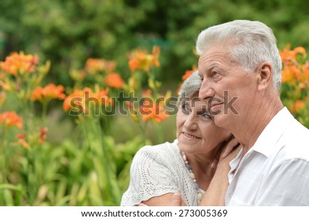 loving elderly couple on a background of flowers
