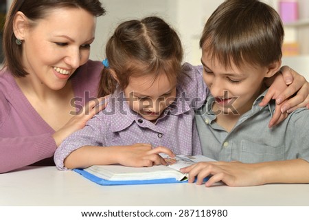 Mom with her children reading a book
