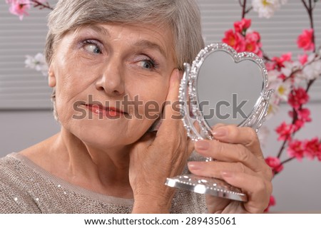 portrait of an elderly woman with mirror