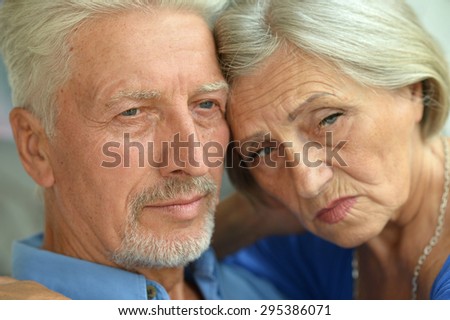 Portrait of a sad senior couple at home