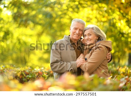 Happy senior couple relaxing in autumn park