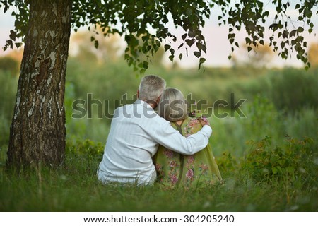 Portrait of happy elderly couple  on nature at summer,back view