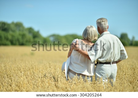 Loving mature couple in field  at summer,back view
