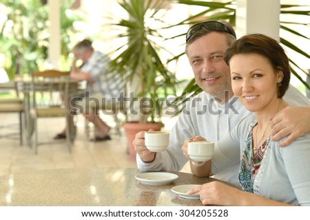 Happy couple with coffee on the table