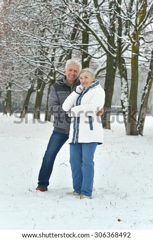 Portrait of elderly couple having fun outdoors in winter forest