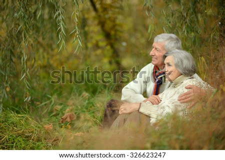 Portrait of a happy elderly couple in autumn park