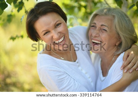 senior Mother and her nice daughter in  park
