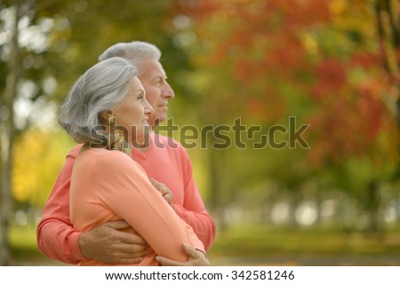 Beautiful caucasian elderly couple in the park in autumn