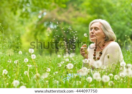 Senior woman in green park
