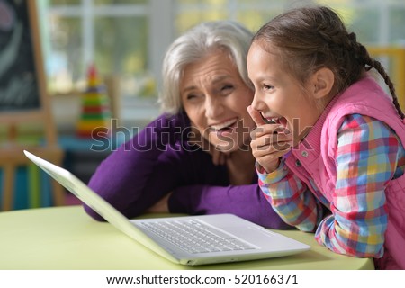 Grandmother and granddaughter with laptop