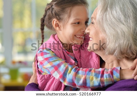 Grandmother and granddaughter hug