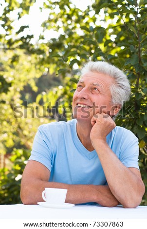 happy elderly man in a summer park