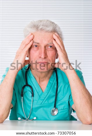 older doctor withs tethoscope on a white background