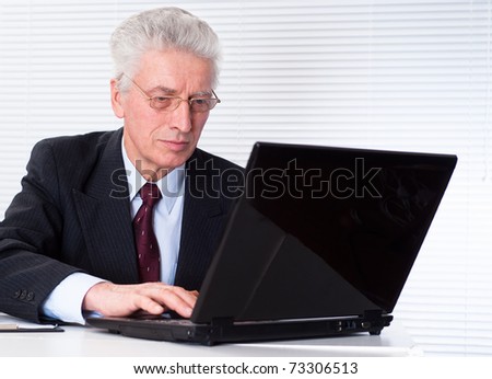 senior businessman with laptop on white background