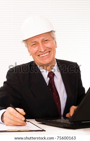 old builder in the helmet on a white background