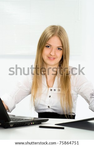 beautiful girl in a business suit working in the office