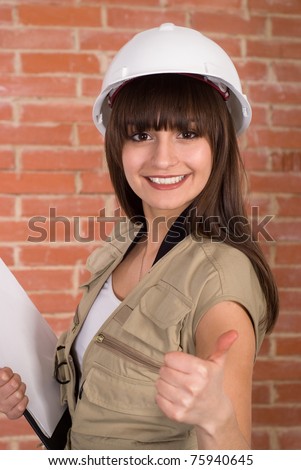 pretty young worker  in a white helmet