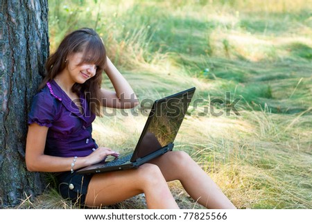 portrait of a girl with laptop at nature