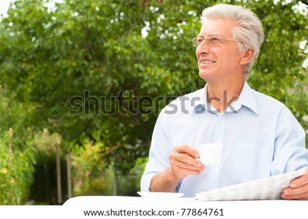 portrait of a man reading a newspaper at nature
