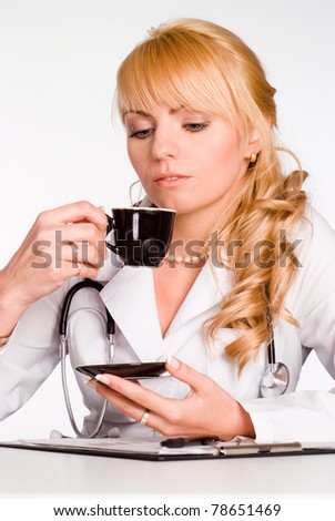 young doctor drinks tea at the table