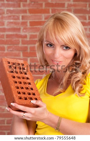 portrait of a nice girl on a brick bdackground