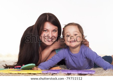 family of a two playing on carpet