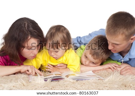 cute family of a four  lying on carpet