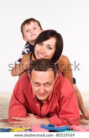 portrait of a  family lying on carpet