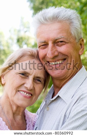 happy old couple posing at the nature