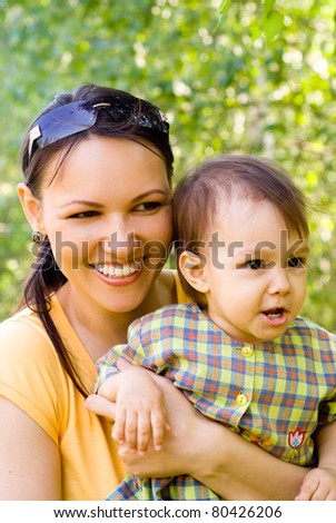 happy mom with her daughter in a park