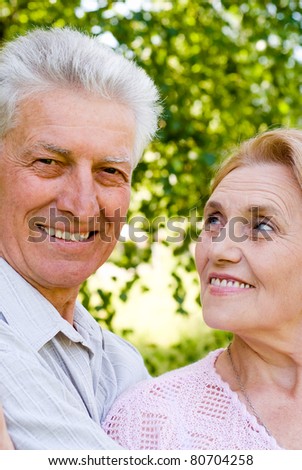 happy old couple posing at the nature