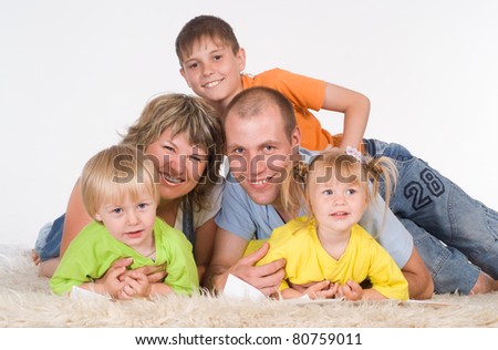 nice family of a five lying on a carpet