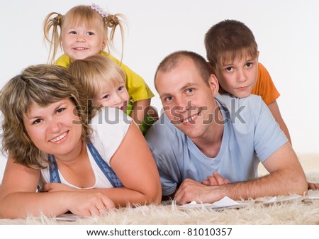 nice family of a five lying on a carpet