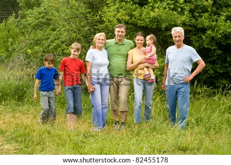 family of a seven people at nature