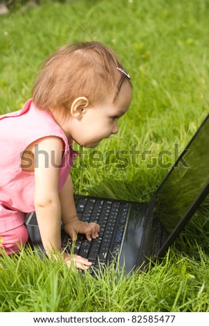 little girl with a laptop at nature