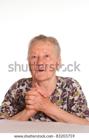 cute granny posing at table on a white
