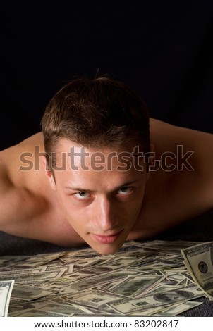 young pretty guy with cash on a black