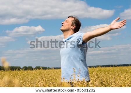 portrait of a man standing at field - stock photo