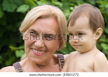 happy granny with a baby at nature
