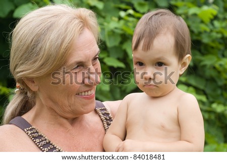 happy granny with a baby at nature