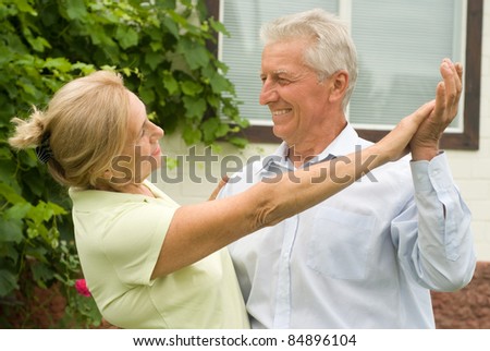 portrait of a nice elderly couple dancing