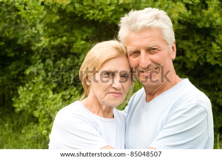 cute old couple posing at the nature