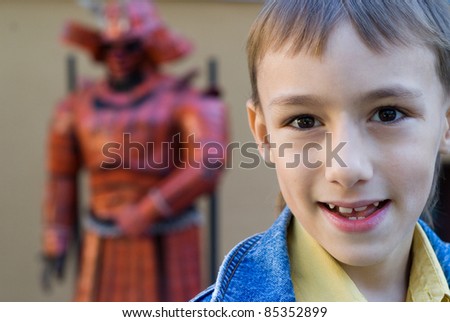 portrait of a cute young boy at statue