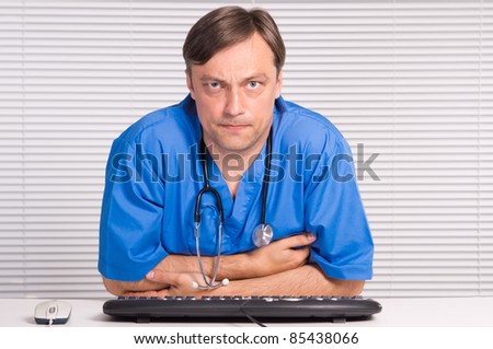 portrait of a cute doctor at computer