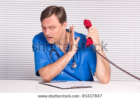 cute doctor with a telephone at table