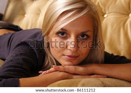portrait of a nice girl posing at sofa
