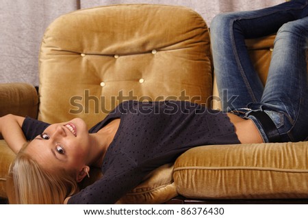 portrait of a nice girl posing at sofa