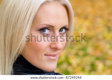 cute adult  girl posing at autumn park