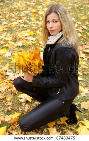 portrait of a cute girl posing in autumn park