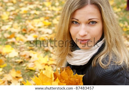 portrait of a cute girl posing in autumn park
